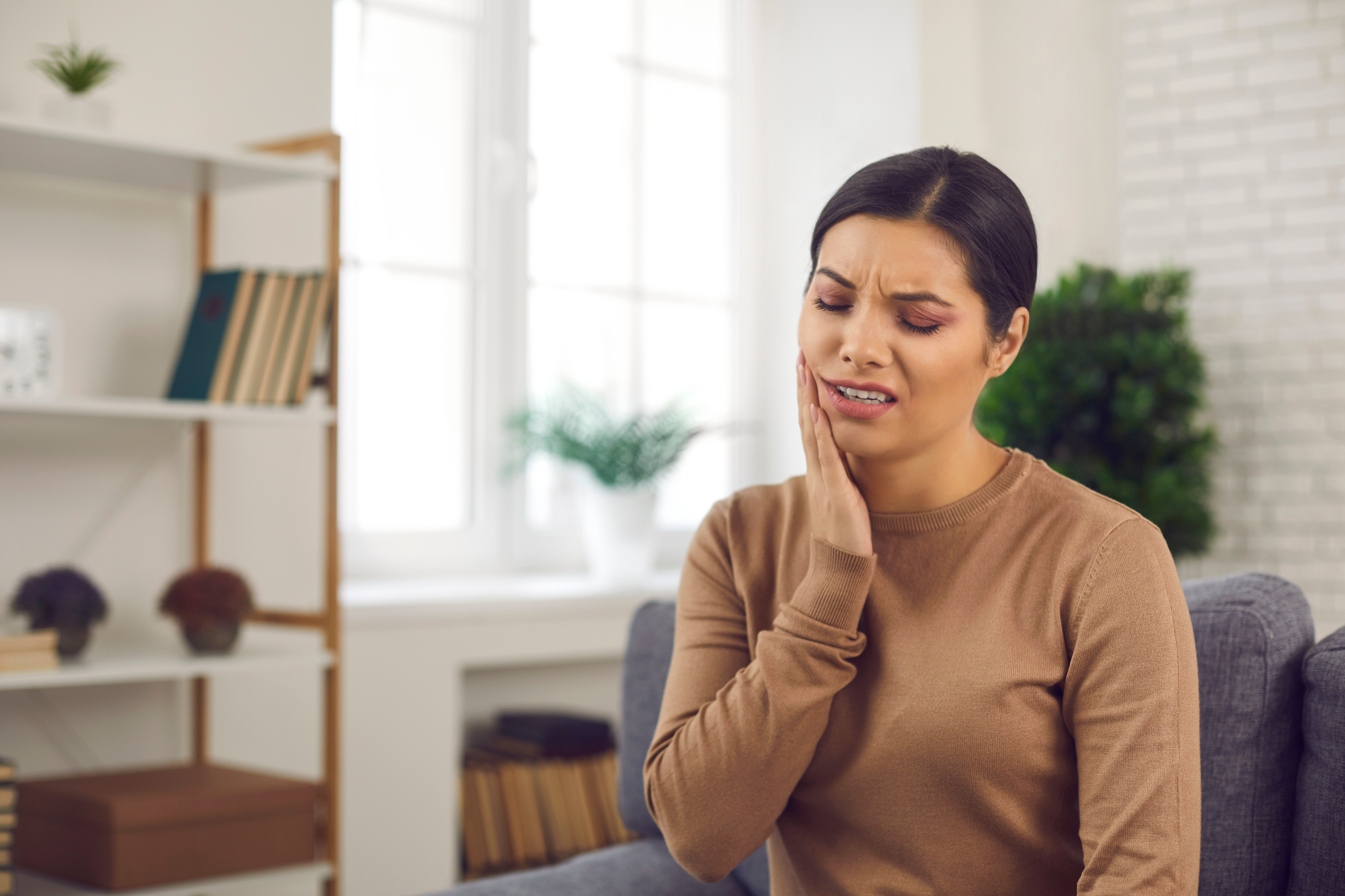 A woman experiencing dental pain