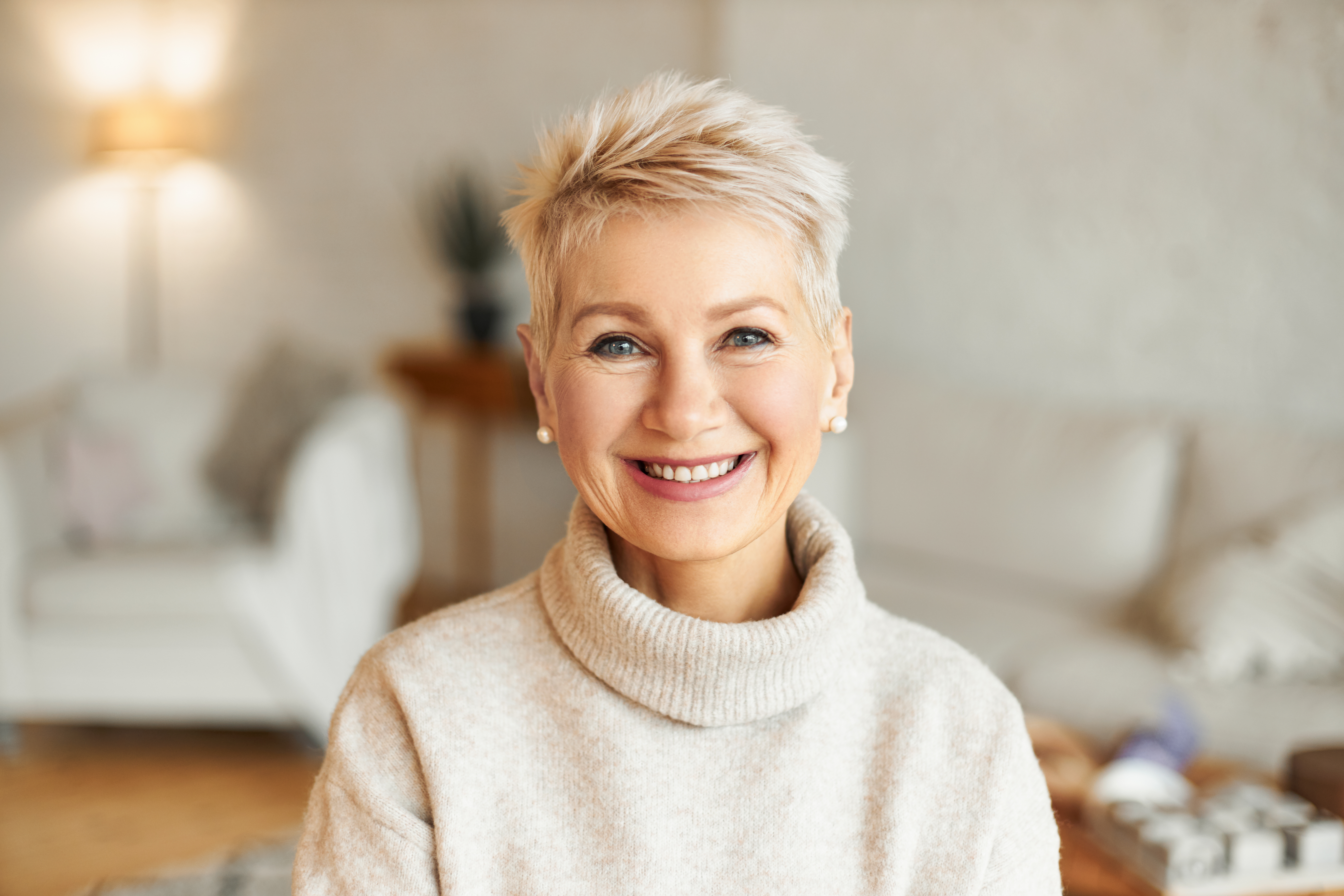 Smiling older woman adjusting her glasses